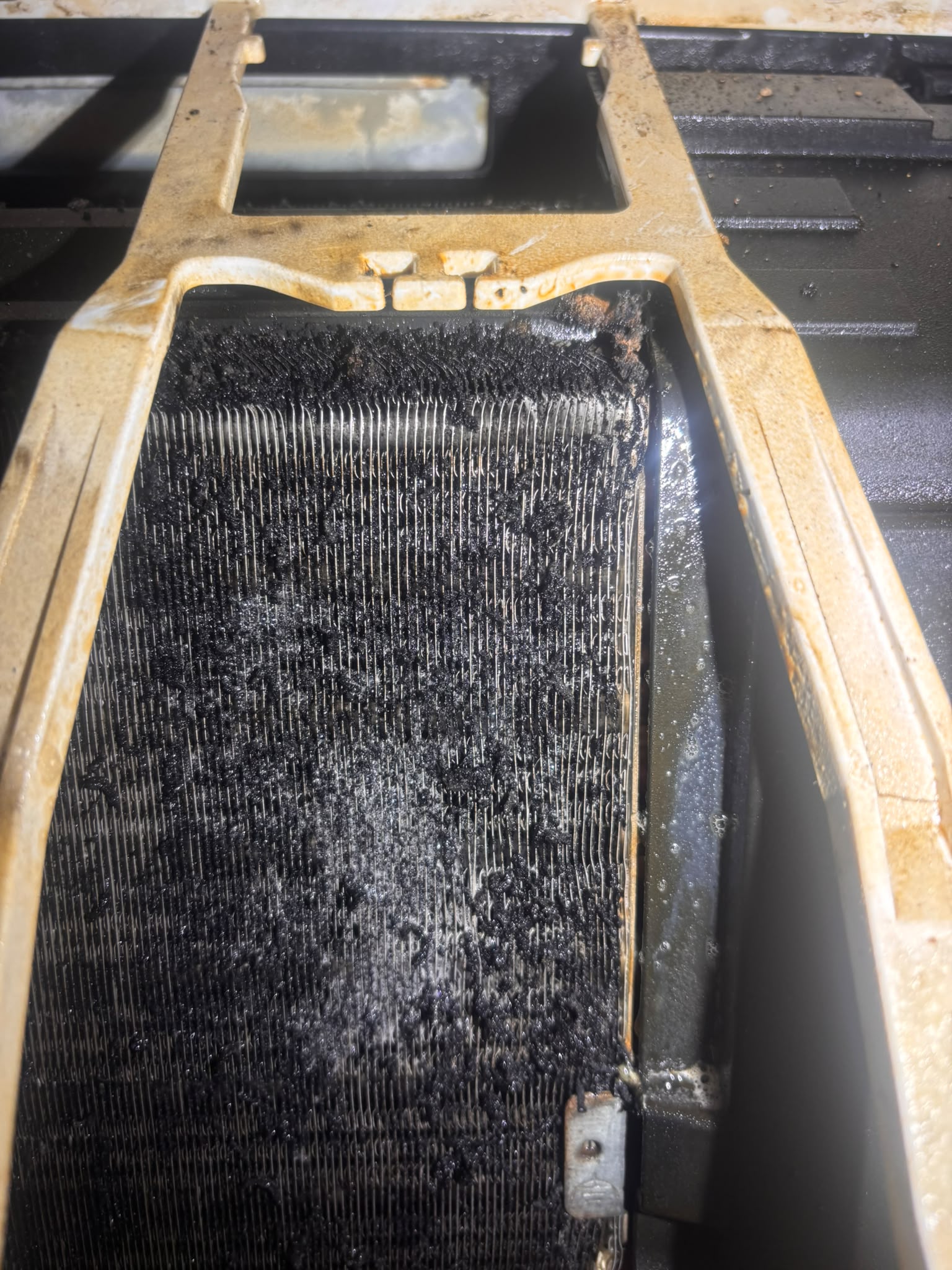 Visible build-up across the exposed coil fins.